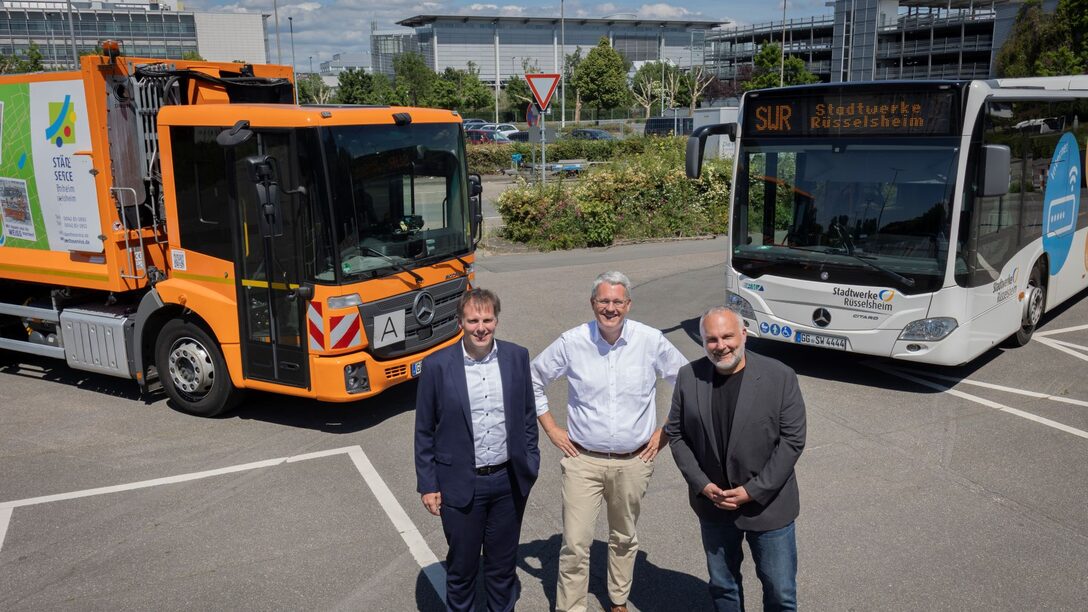 Maik Landwehr, Patrick Burghardt und Andreas Lier. Im Hintergrund sind die Opel-Zentrale und rechts eines der beiden Parkhäuser zu sehen.