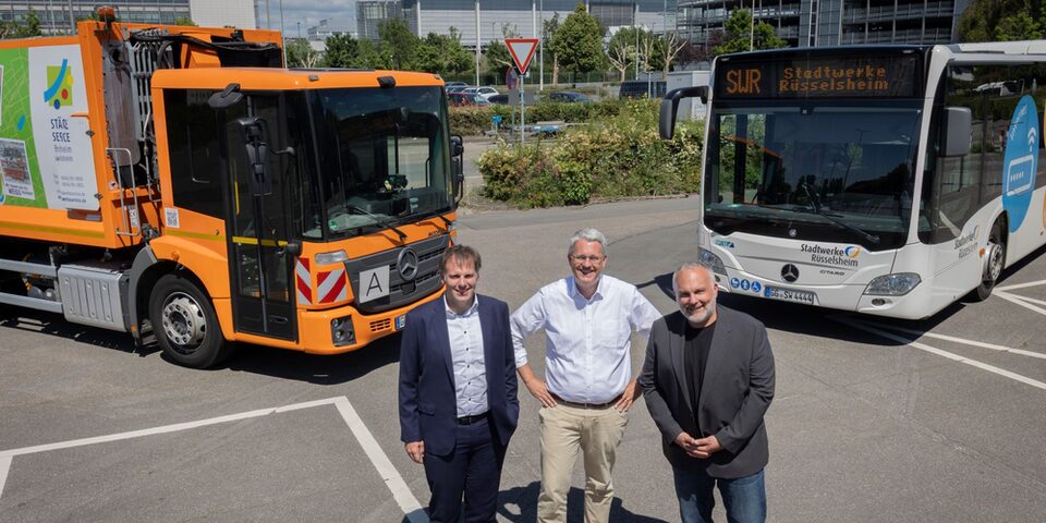 Maik Landwehr, Patrick Burghardt und Andreas Lier. Im Hintergrund sind die Opel-Zentrale und rechts eines der beiden Parkhäuser zu sehen.
