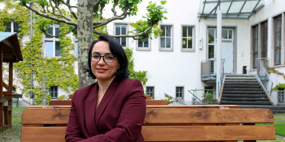 Ouarda Bouy sitzt im Innenhof des Rathaus Rüsselsheim