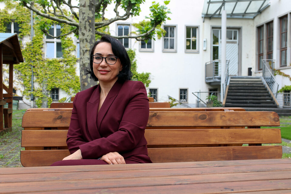 Ouarda Bouy sitzt im Innenhof des Rathaus Rüsselsheim