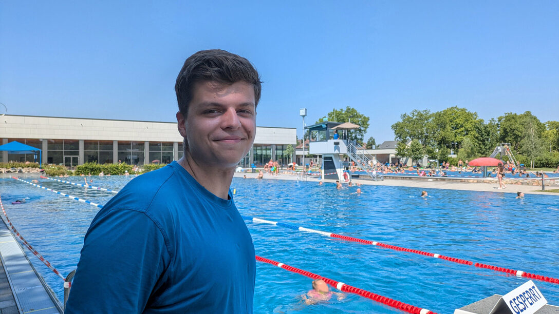 Nils Seewald steht im blauen T-Shirt vor den Startblöcken des Schwimmerbeckens im Freibad An der Lache.