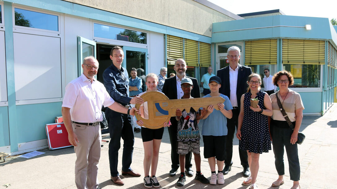 Stadtrat Simon Valerius, Bürgermeister Murat Karakaya & Oberbürgermeister Patrick Burghardt im Gruppenfoto bei der symbolischen Schlüssel an Schulleiterin Anne Böhm