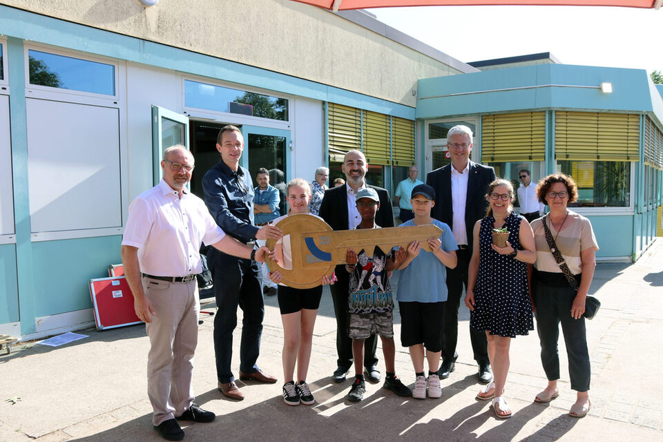 Stadtrat Simon Valerius, Bürgermeister Murat Karakaya & Oberbürgermeister Patrick Burghardt im Gruppenfoto bei der symbolischen Schlüssel an Schulleiterin Anne Böhm