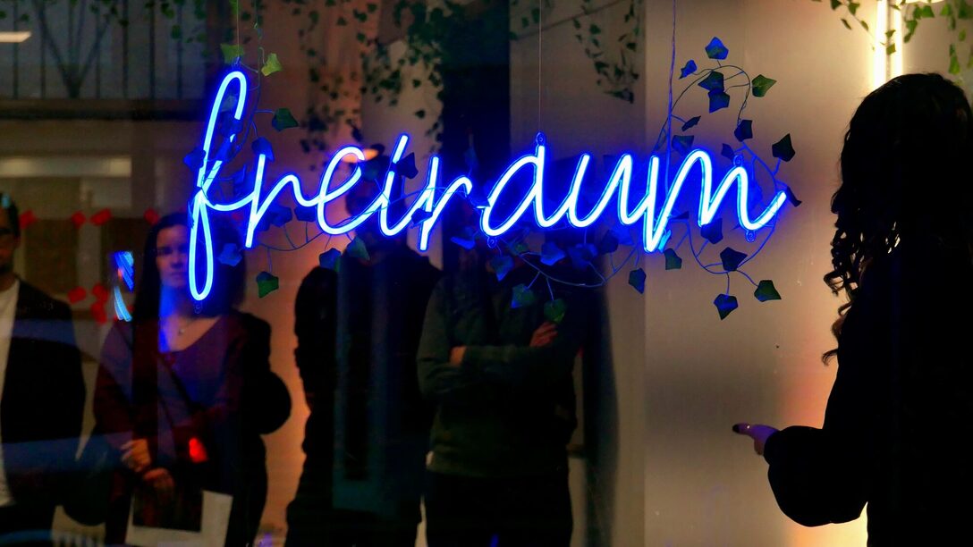 Außenansicht Atelier freiraum f3 bei Nacht, im Schaufenster ist die Leuchtschrift "freiraum" zu sehen